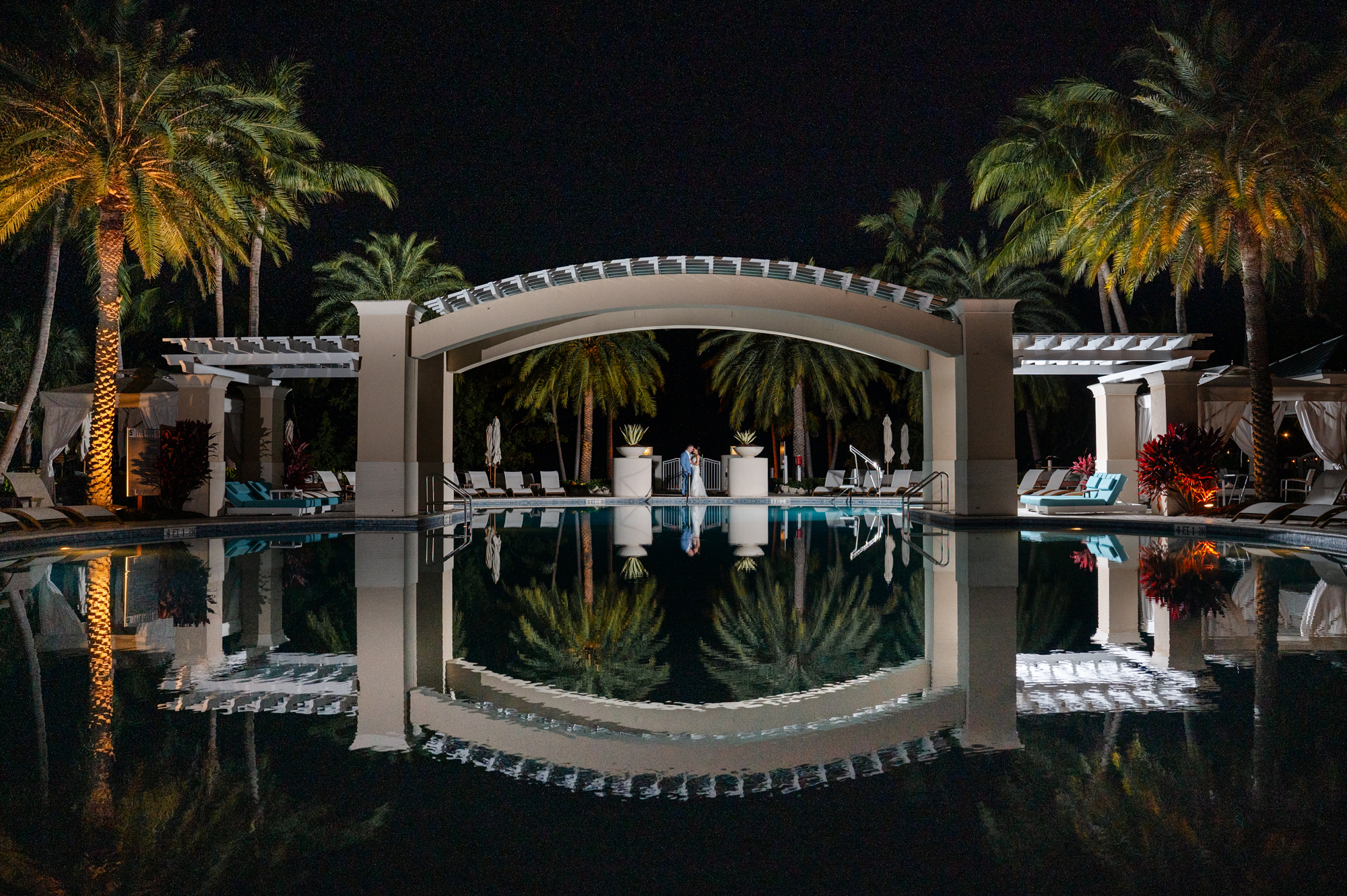 epic reflection with couple by pool