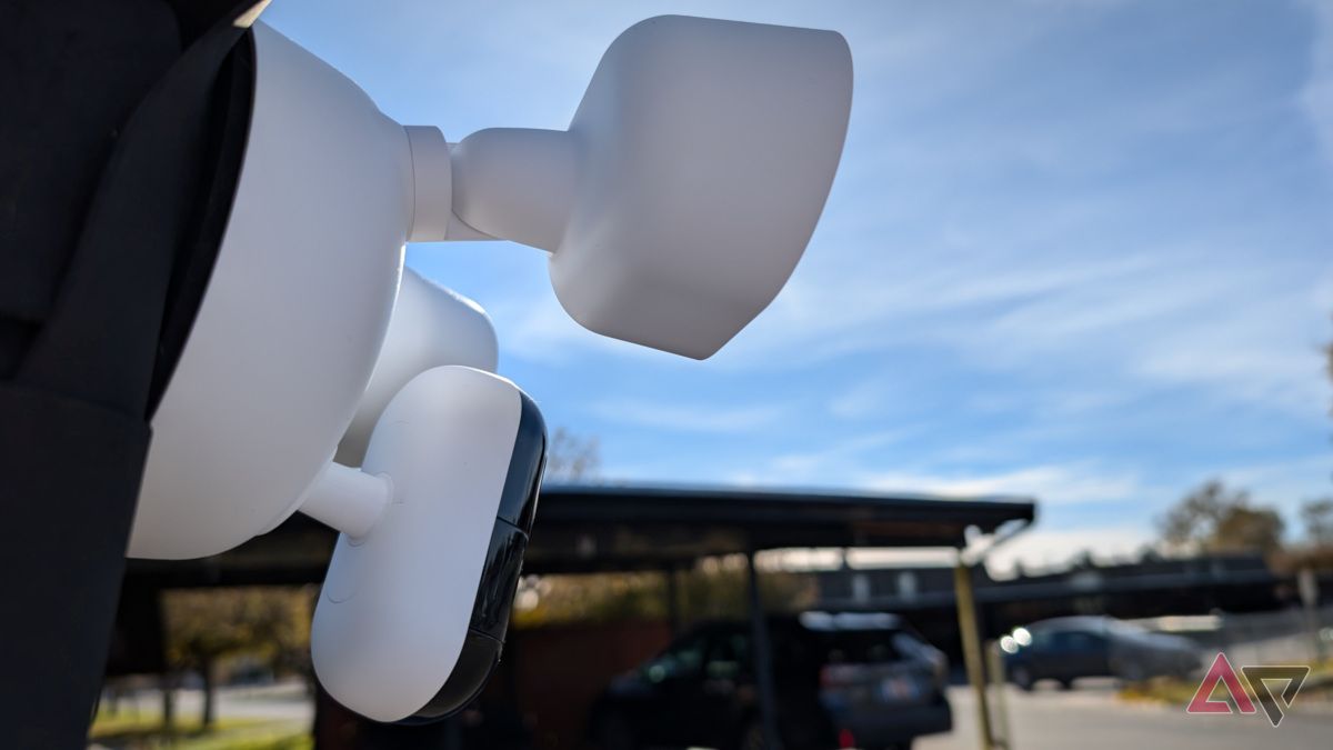 Arlo Wired Floodlight Camera with sky and parking lot in background