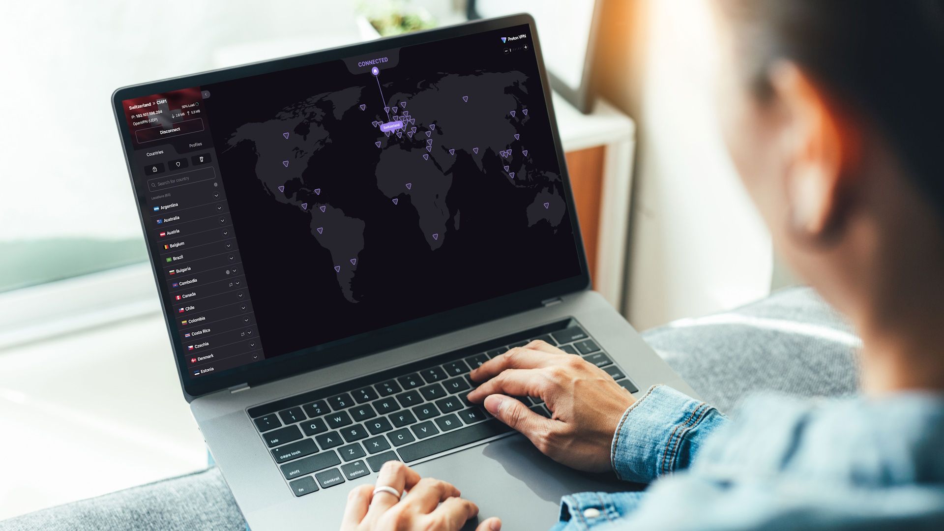 A person browsing Proton VPN app on a laptop