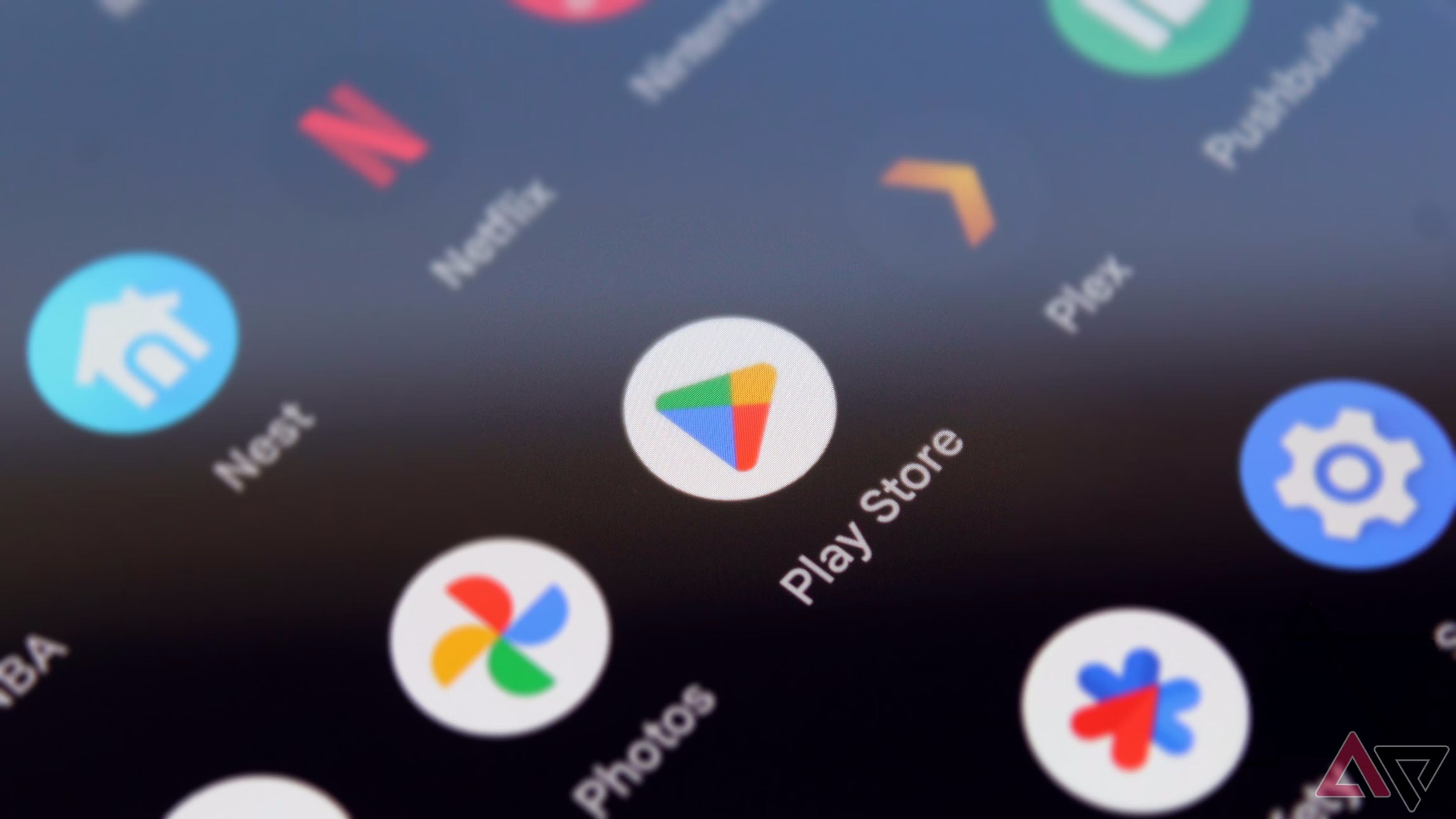 A cropped image of a smartphone display with the Google Photos and Play Store icons in focus