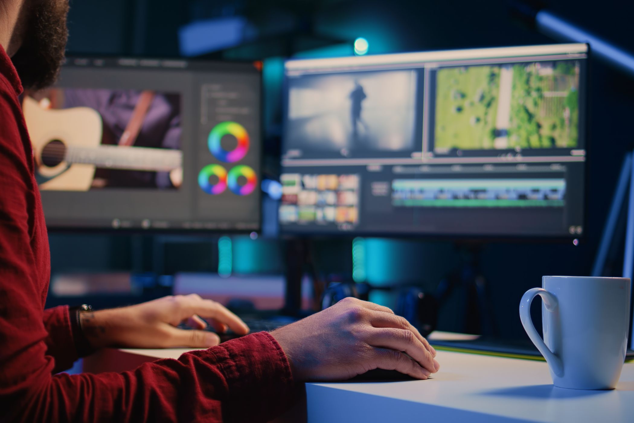 Man editing video multitasking on pc with multiple monitors