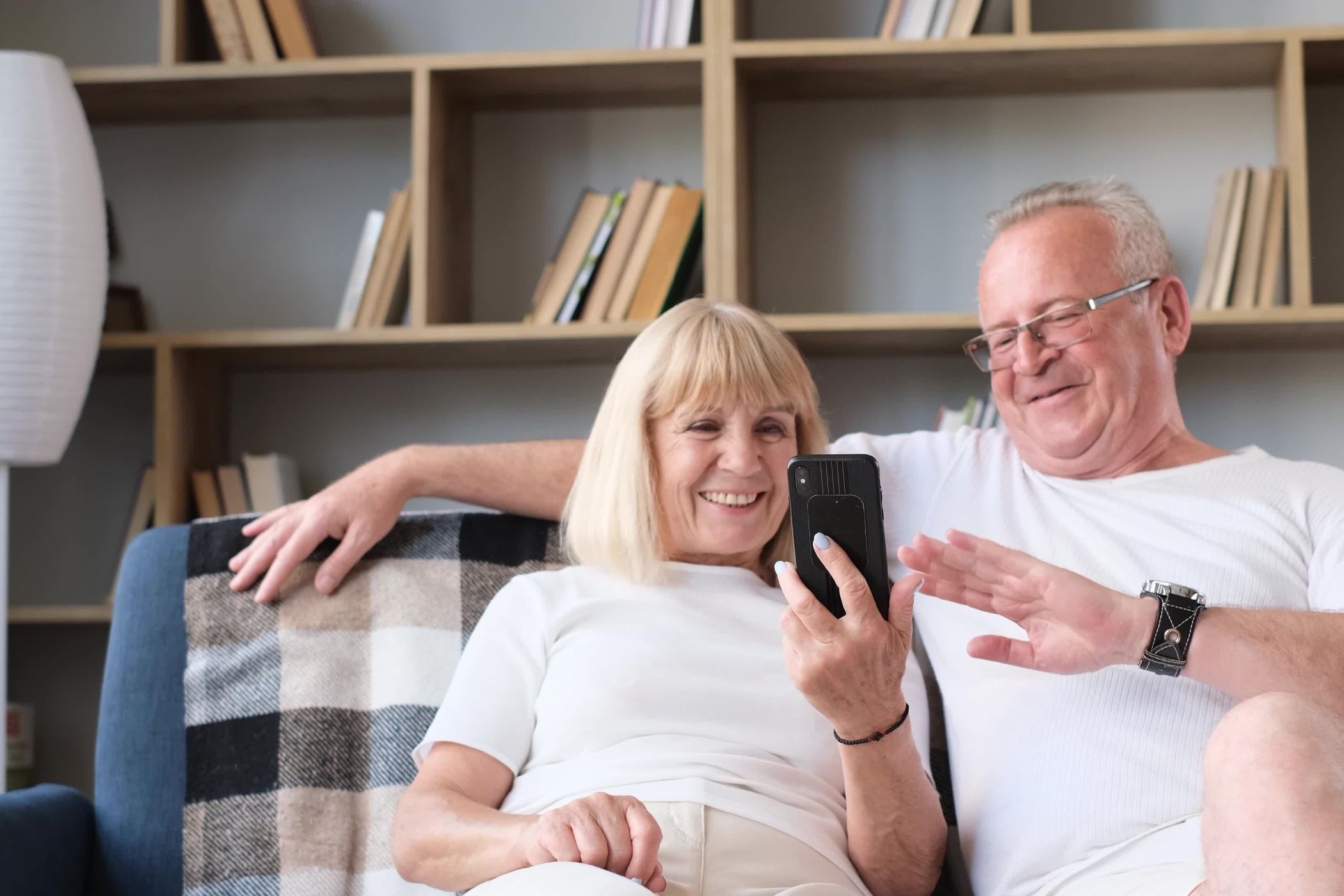 An older couple video calling on their phone