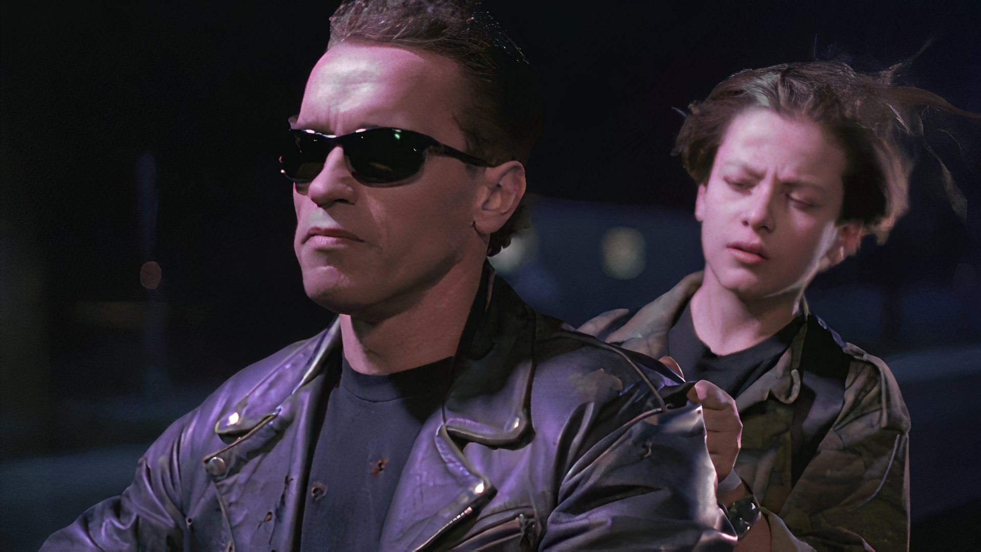 Edward Furlong riding on the back of a motorcycle driven by Arnold Schwarzenegger in Terminator 2: Judgment Day