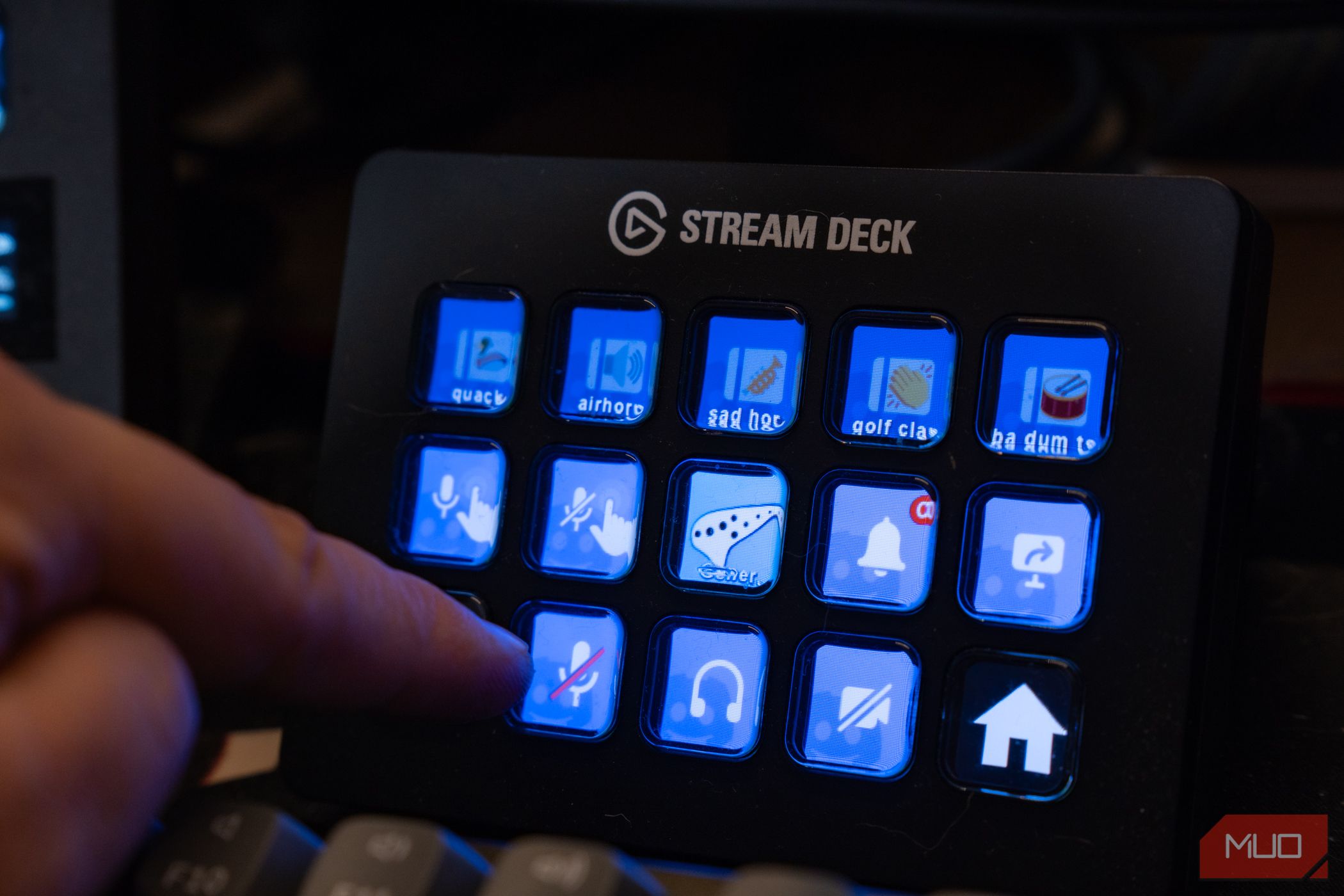 Elgato Stream Deck with Discord plugin icons and finger reaching for one.