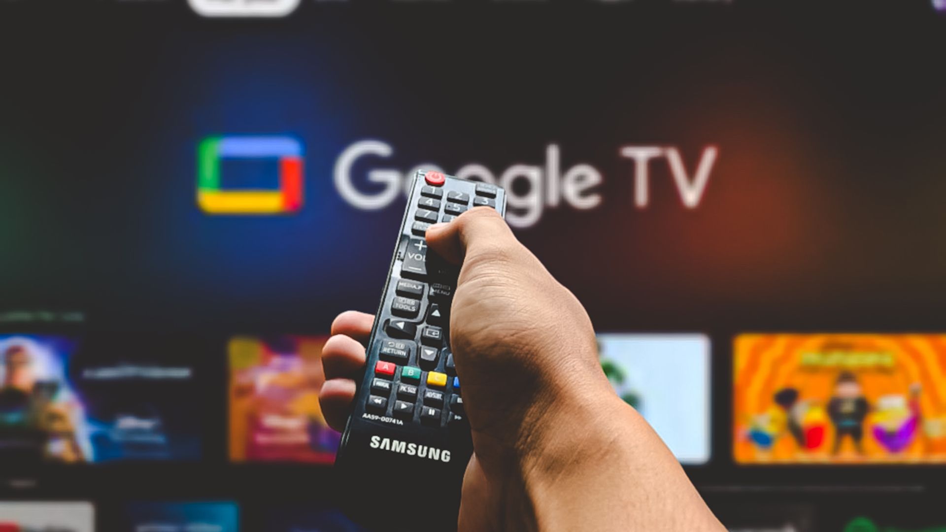 man pointing remote control at google tv