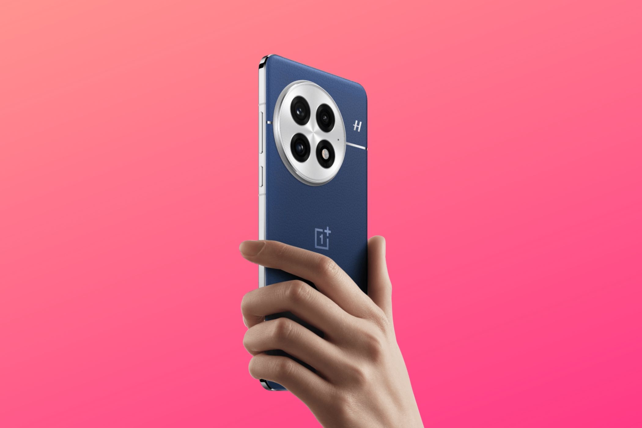 Render of a OnePlus 13 being held in hand with a pink background