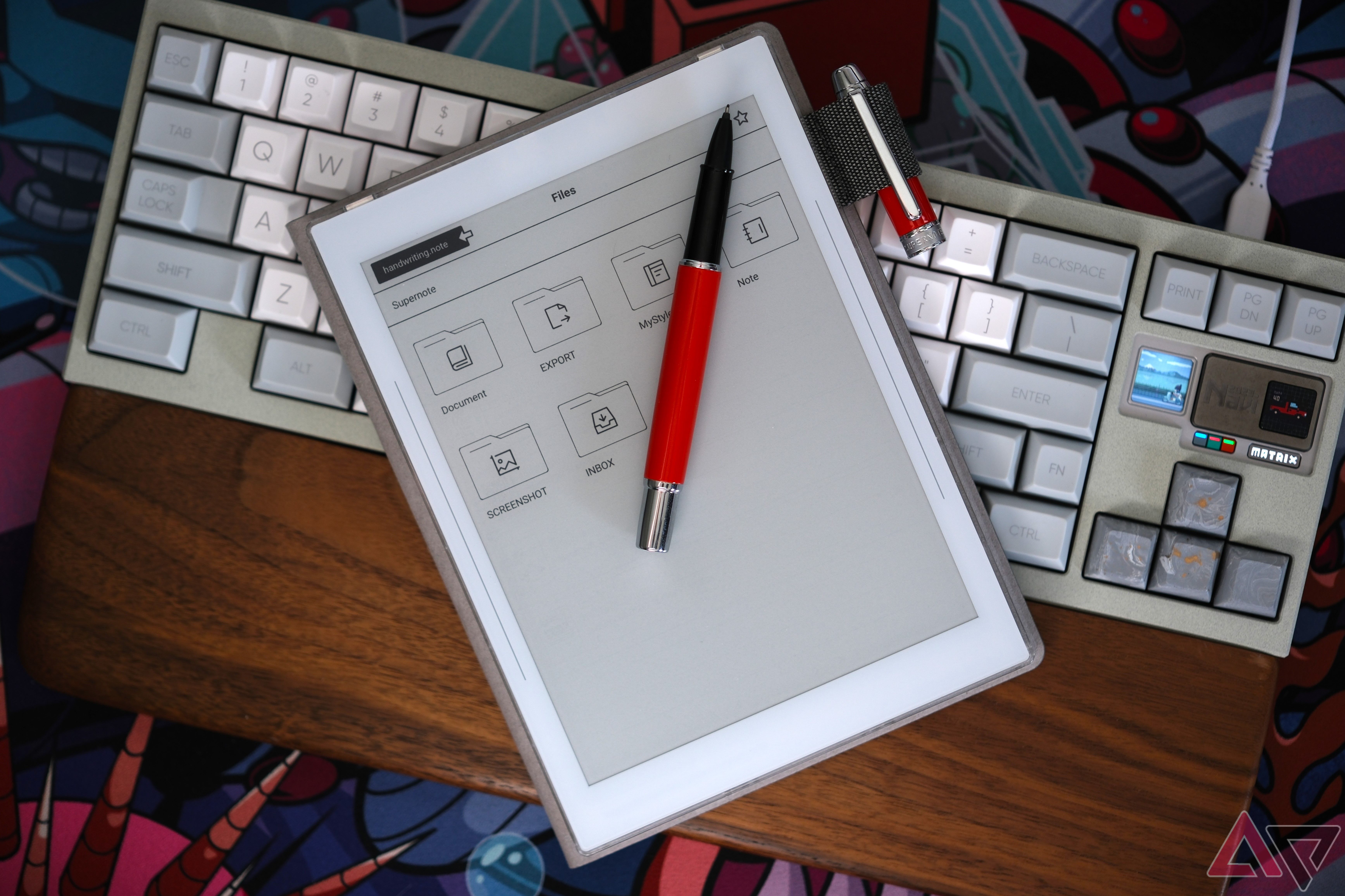 Supernote Nomad sitting on top of Matrix navi keyboard with pen out laying on top of device