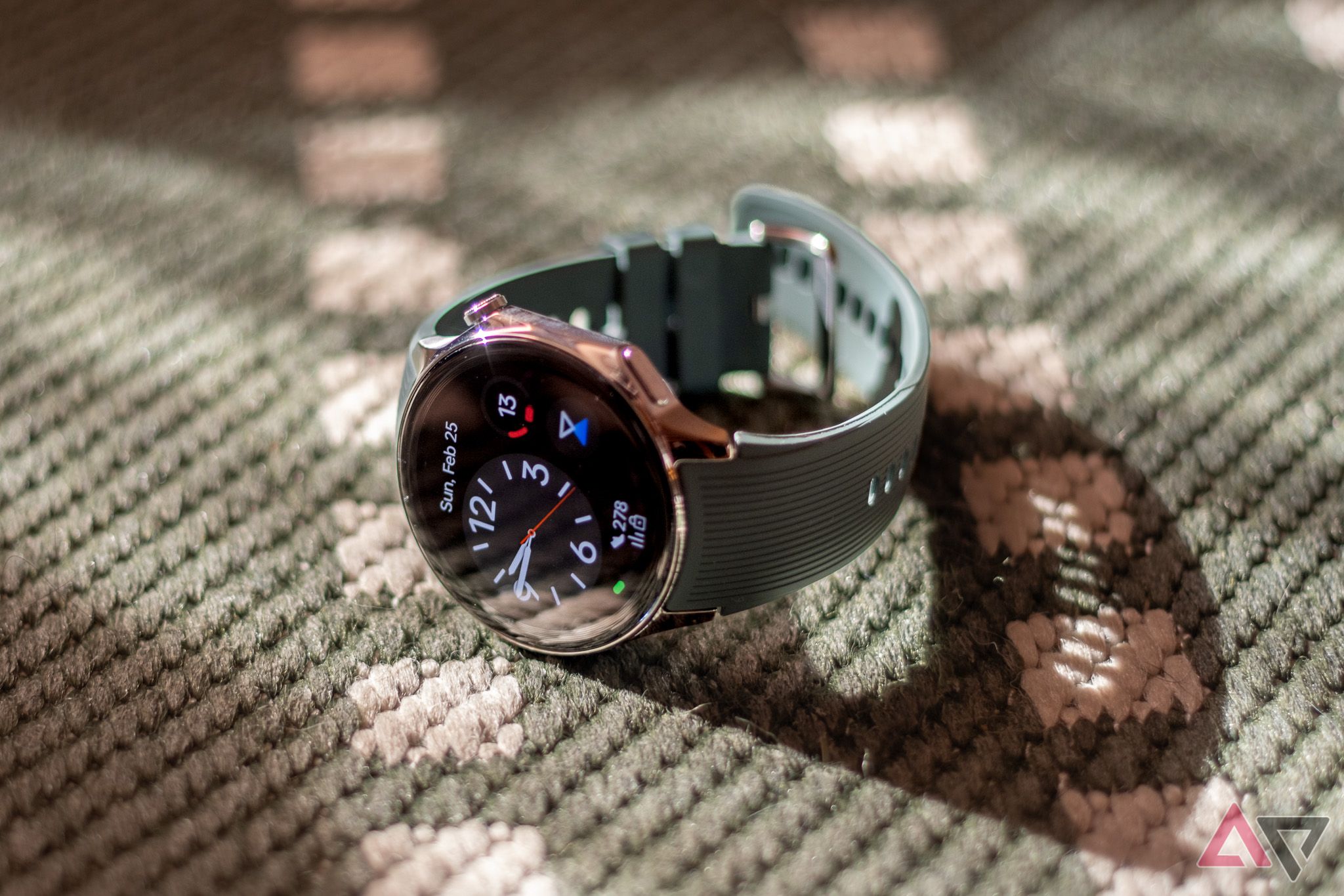 OnePlus Watch 2 sitting on a green rug