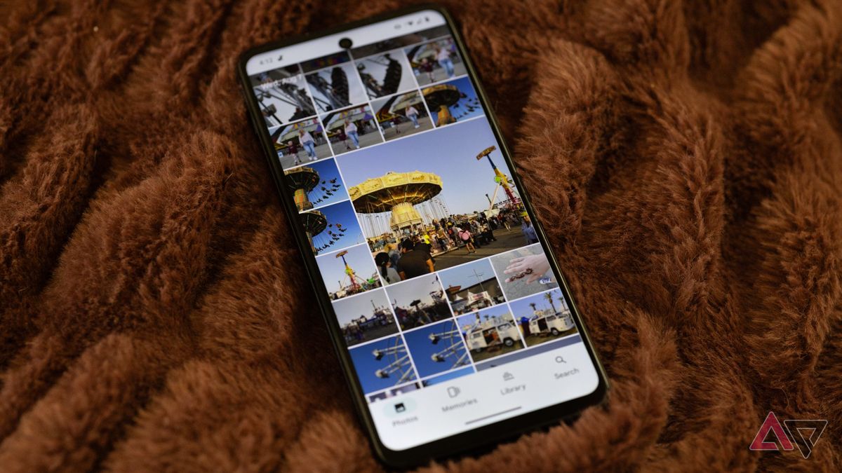An HMD Vibe with Google Photos open laying on a brown blanket