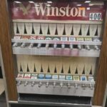 buying cigarettes from a vending machine.jpeg