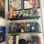 wall of 80s 90s pop culture physical media in my home office.jpeg